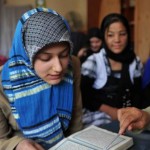 Afghan teacher Meher Afroza (R) teachs K