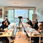 a-group-of-people-sitting-at-a-table-description